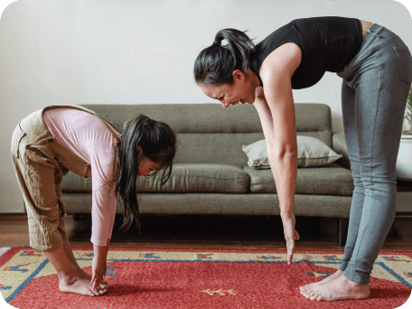 Mother and daughter exercising and stretching together