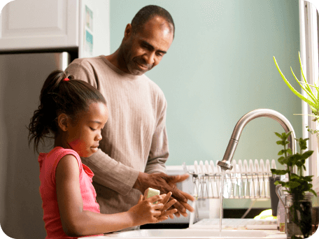 Father and her daughter preparing food together